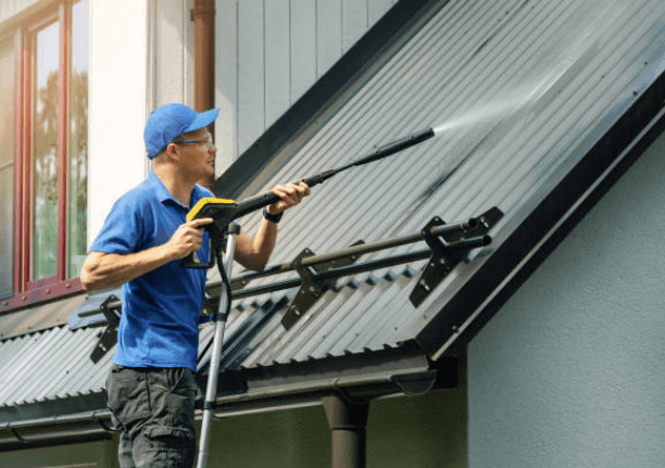 man cleaning roof